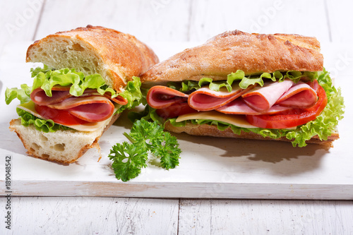 two sandwiches with ham and vegetables
