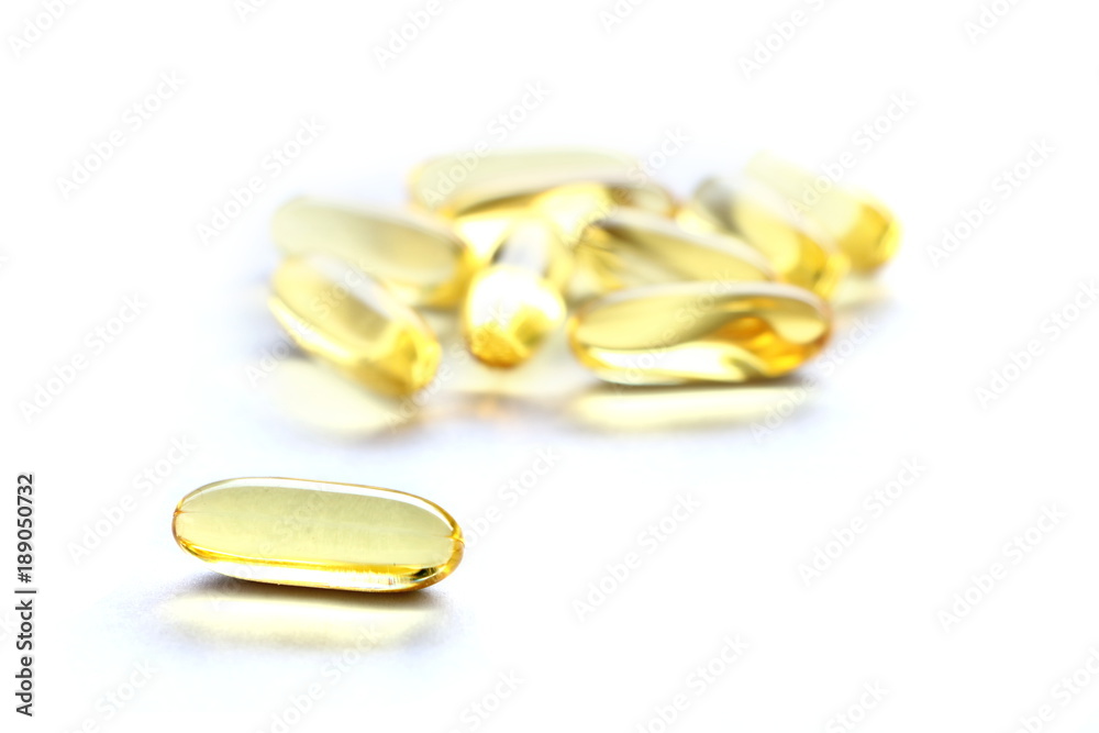 Close up yellow Cod Liver Oil capsule on white background, fish oil is a dietary supplement derived from liver of cod fish, have omega-3 fatty acids, EPA, DHA, vitamin A and D Close up yellow Cod Liver Oil capsule on white background, fish oil is a dietary supplement derived from liver of cod fish, have omega-3 fatty acids, EPA, DHA, vitamin A and D