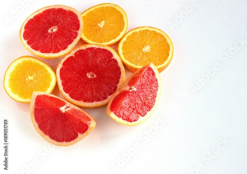 Slices oranges fruit and grapefruit on white background copy space