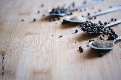 Various types of pepper on a wooden background