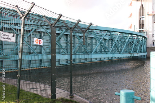 Barrier is closing and goes into the water at the Algerakering, large water barrier to protect the land below sealevel behind it in Krimpen aan den IJssel, The Netherlands photo