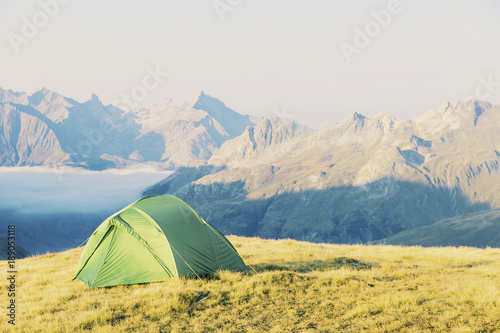 Tent standing on a mountain top.