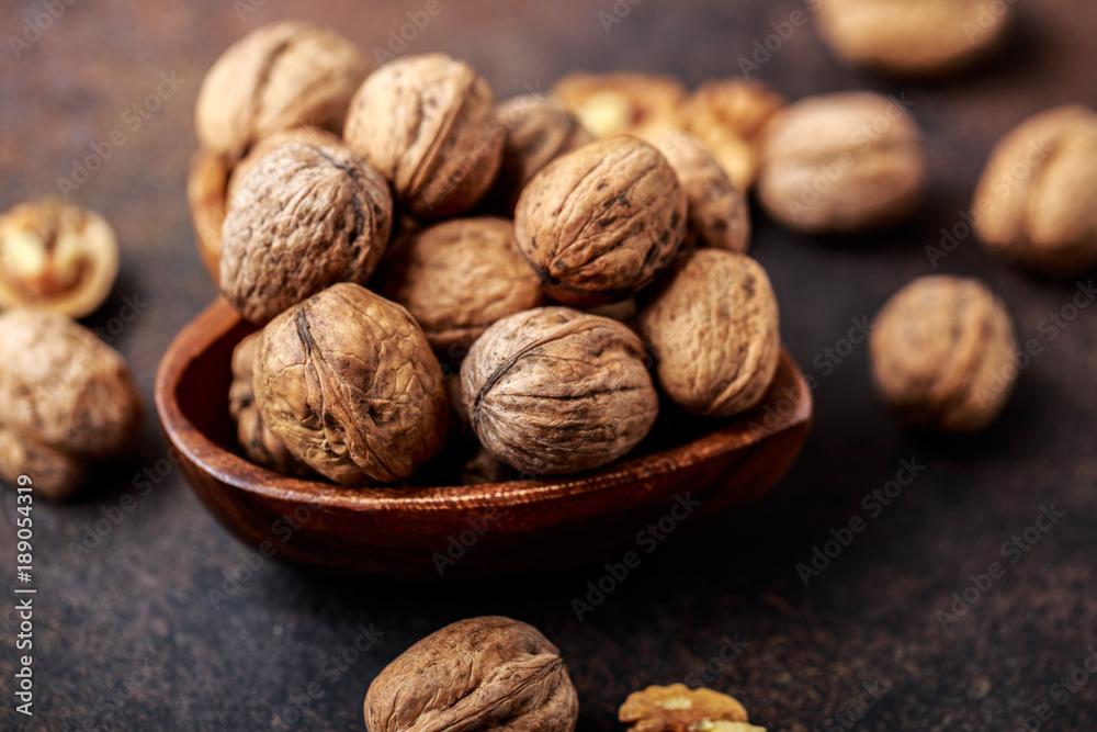 Walnuts. Walnut kernels and whole walnuts on rustic table. 
