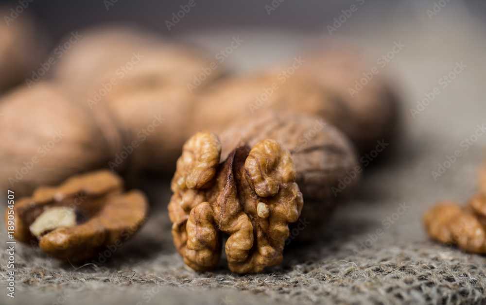 Walnuts. Walnut kernels and whole walnuts on rustic table. Walnuts. Walnut kernels and whole walnuts on rustic table.