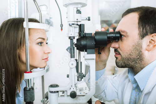 patient and doctor, during a vision check while in a medical clinic