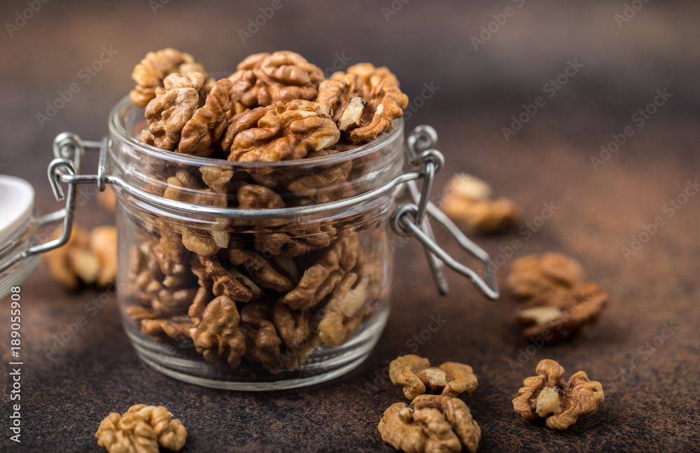 Walnuts. Walnut kernels and whole walnuts on rustic table. Walnuts. Walnut kernels and whole walnuts on rustic table.