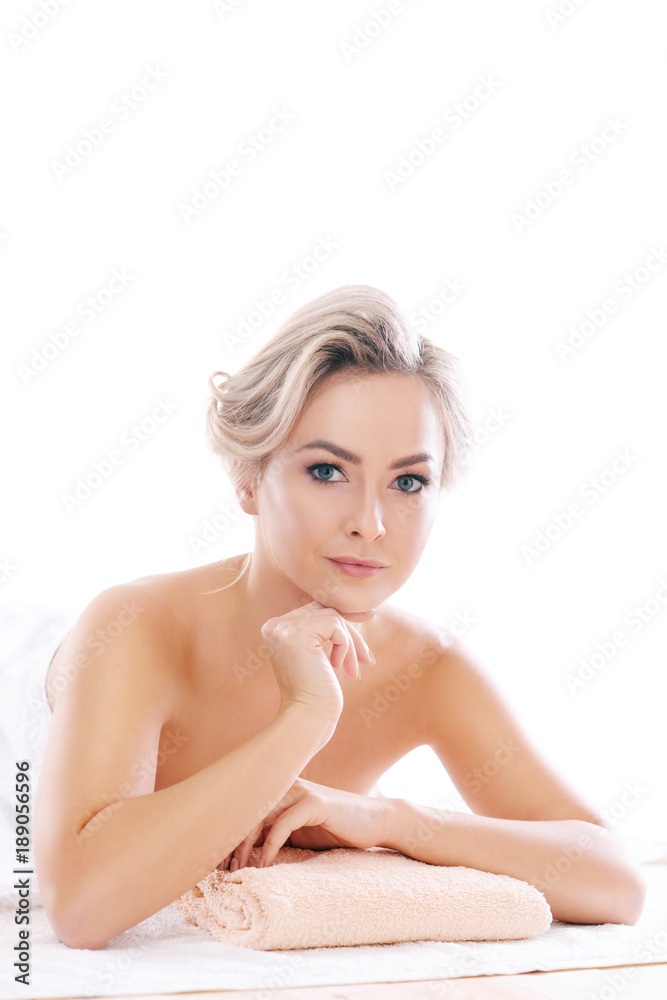 Fototapeta premium Young, beautiful and healthy woman relaxing in spa salon. Rejuvenation therapy and massaging treatments. Recreation concept.
