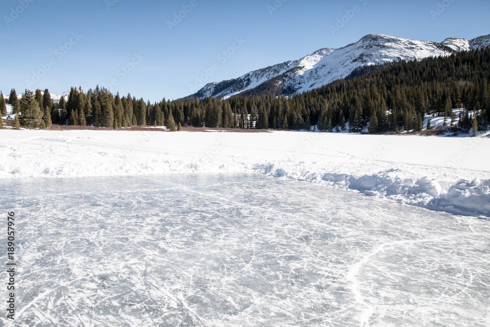 Fototapeta premium Ice rink on Andrew's lake in the San Juan mountains of Colorado