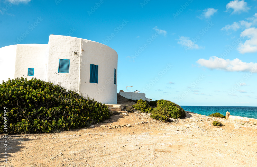 Obraz premium Ibiza, Spain - October 5, 2017 : Beautiful view white and blue building, villa at Ibiza and Formentera islands, Spain. Sea rest and holiday concept.