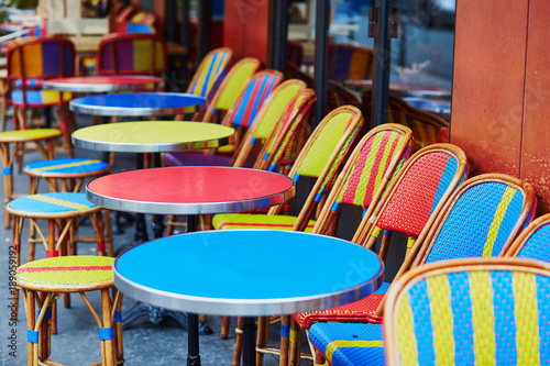 Colorful tables and chairs of outdoor cafe in Paris