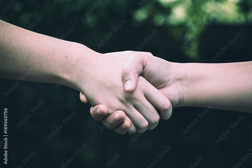 Two colleague shaking hand after accepting agreement; business concept Two colleague shaking hand after accepting agreement; business concept