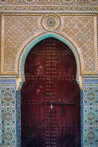 Moroccan door in a tile decorated building wall