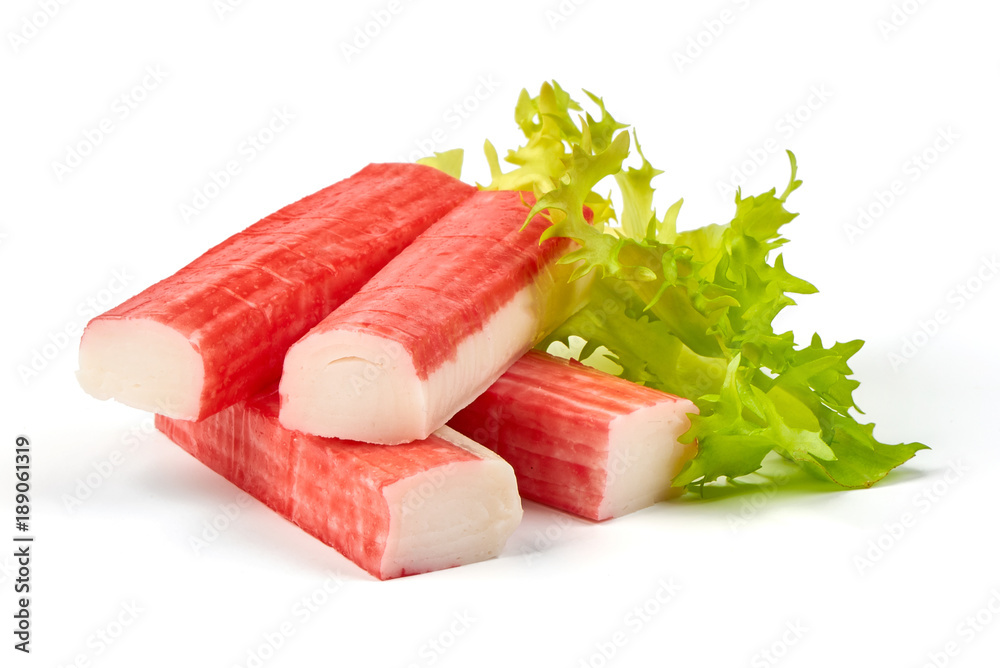 Red sea crab stick with green lettuce, close-up, isolated on white background. Red sea crab stick with green lettuce, close-up, isolated on white background.