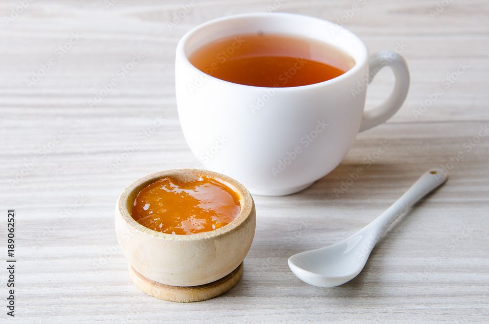 Cup of tea served with orange jam Cup of tea served with orange jam