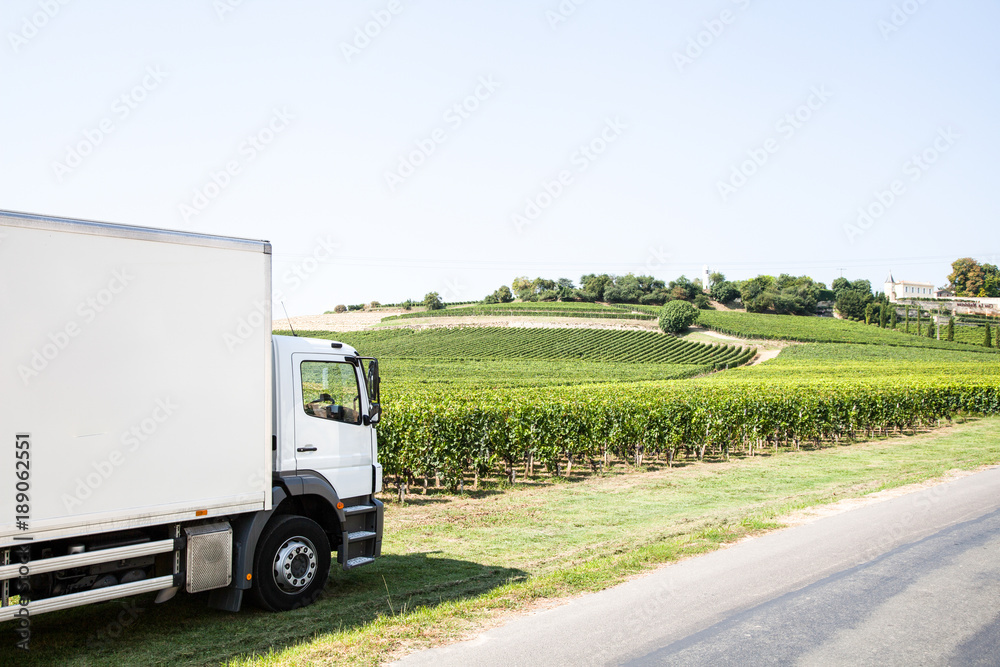 White commercial delivery truck on a countryside background