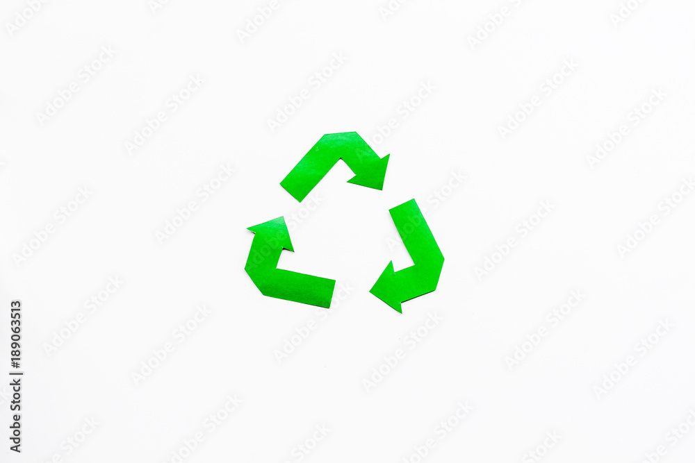Sorting waste and recycle. Green paper recycling sign on white background top view space for text Sorting waste and recycle. Green paper recycling sign on white background top view space for text