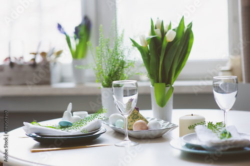 Canvas Print easter and spring festive table decorated in blue and white tones in natural rustic style, with eggs, bunny, fresh flowers and candles