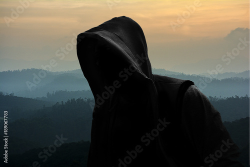 Hooded man on nature background 