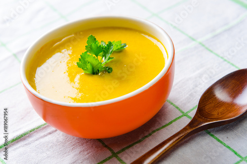 Carrot soup served on the table in bowl