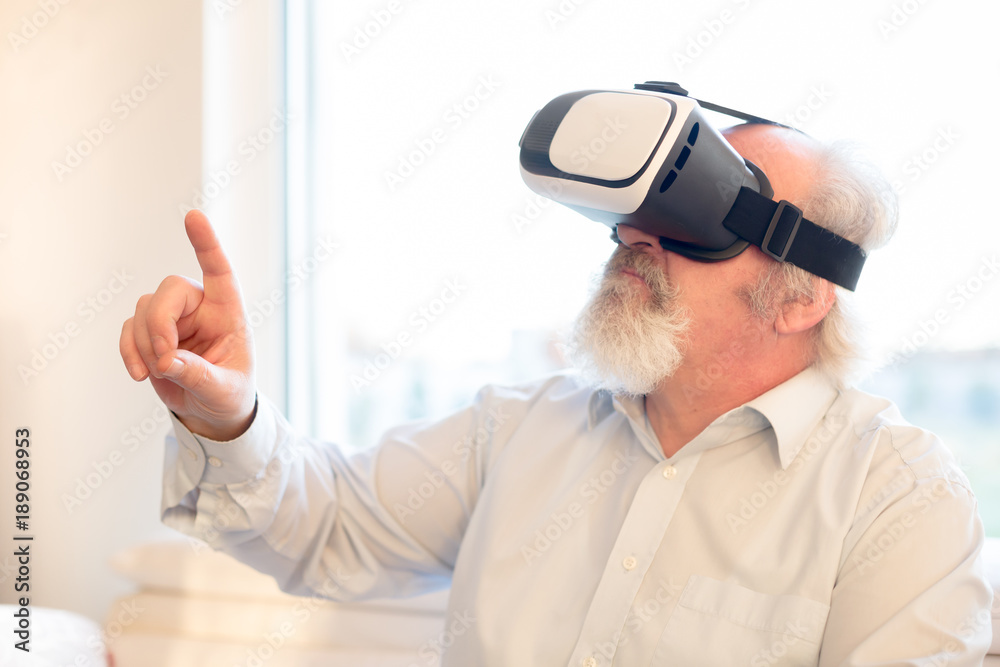 Senior bearded man with VR glasses Senior bearded man with VR glasses