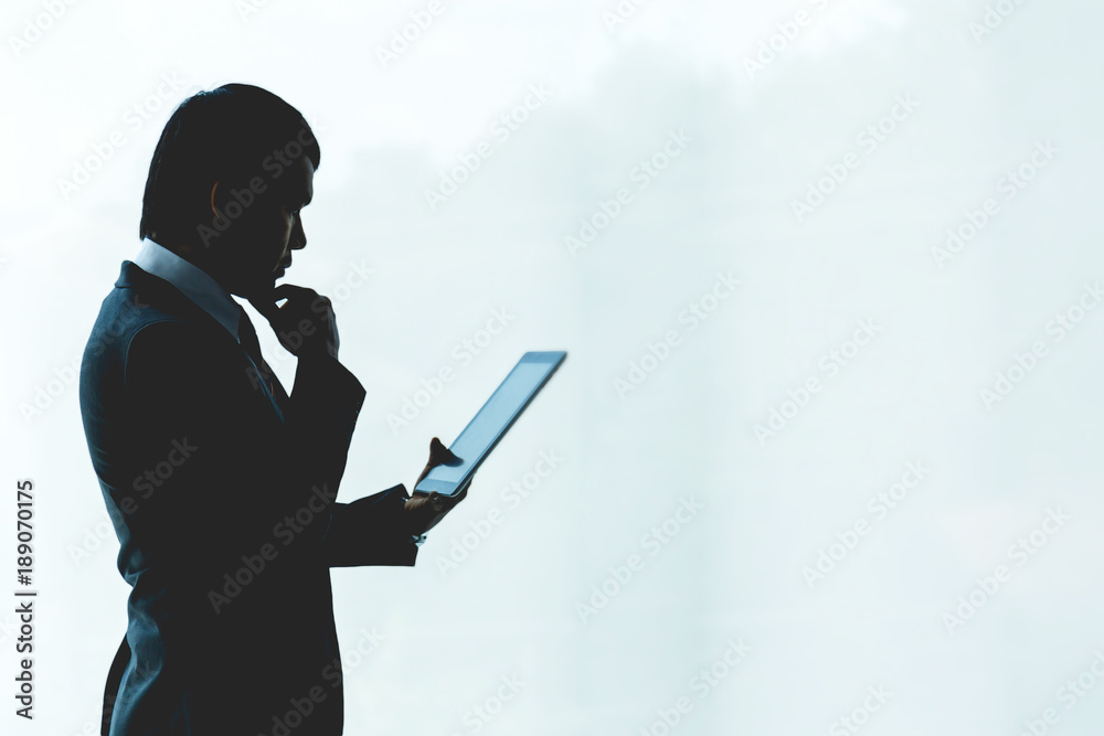 Businessman is using a tablet working in the office.