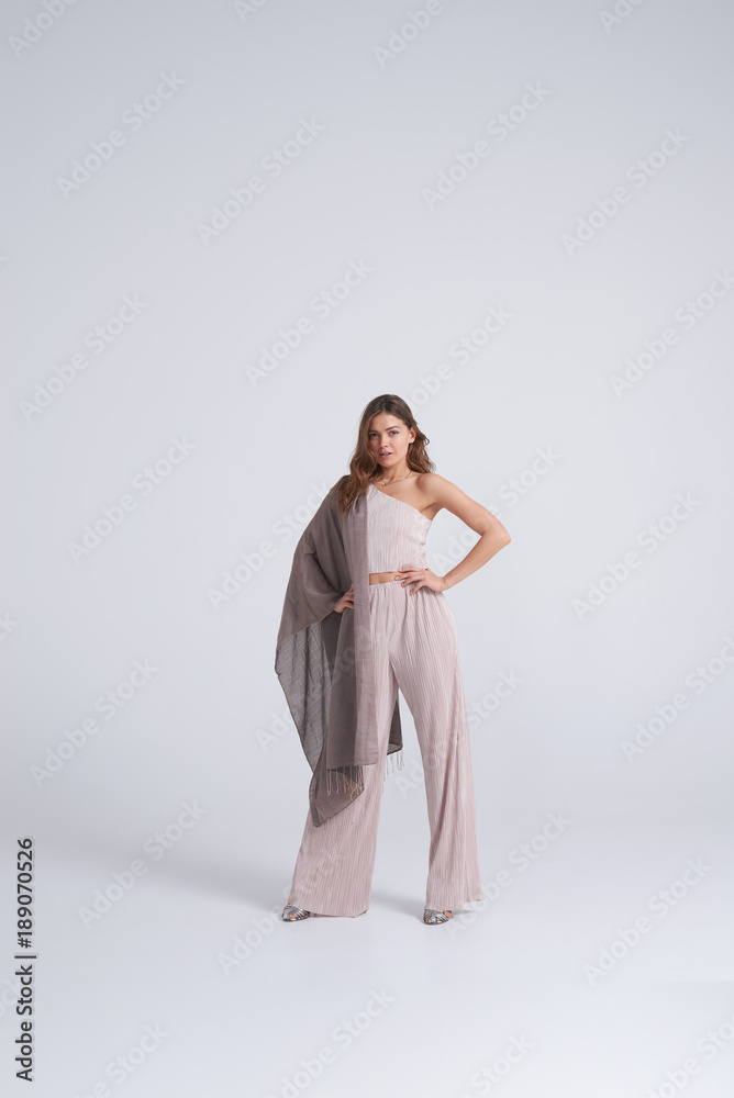 Gorgeous woman in trend clothing and scarf posing Gorgeous woman in trend clothing and scarf posing