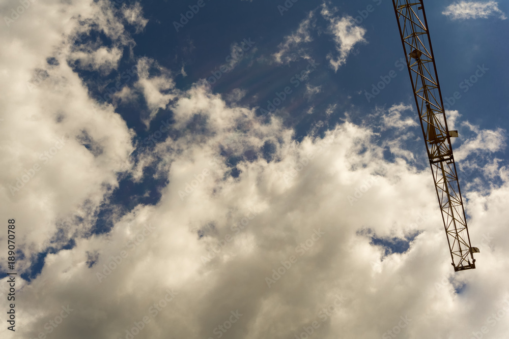 Part of a crane below a cloudy summer sky Part of a crane below a cloudy summer sky