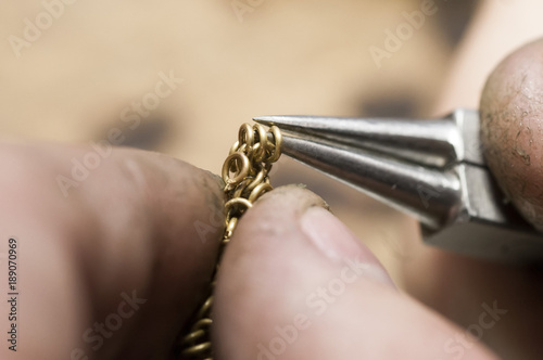 jeweler produces gold jewelry in the workshop