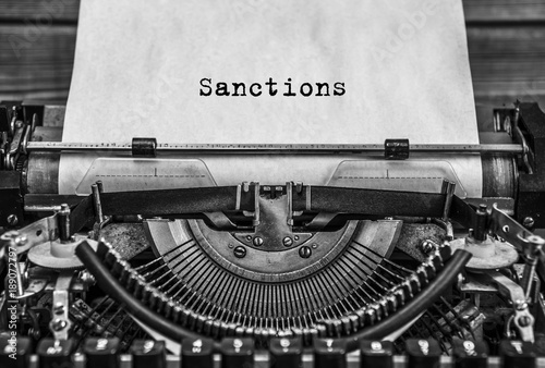 Sanctions, a printed word on an old vintage typewriter. Close up.