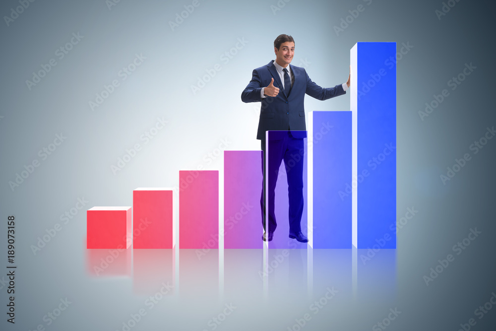 Businessman standing next to bar chart in business concept Businessman standing next to bar chart in business concept
