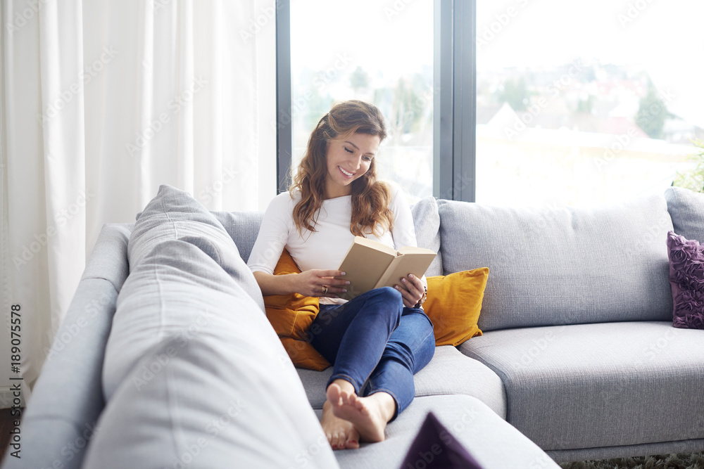 Relaxing with a book at home on my comfy couch Relaxing with a book at home on my comfy couch