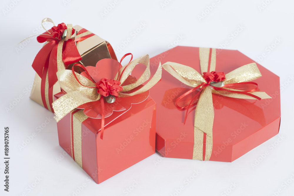 Red and Gold Boxes with candies and gold ribbon bow Red and Gold Boxes with candies and gold ribbon bow