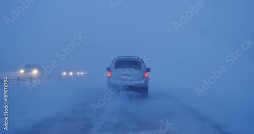 Low visibility driving, traffic headlights in blowing snow during high winds blizzard 4k.mov