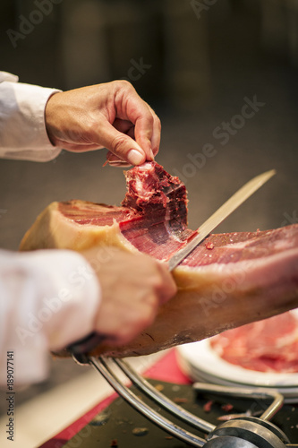 Man slicing a serrano ham