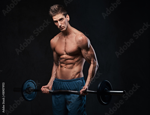Athletic shirtless male biceps barbell workout. 