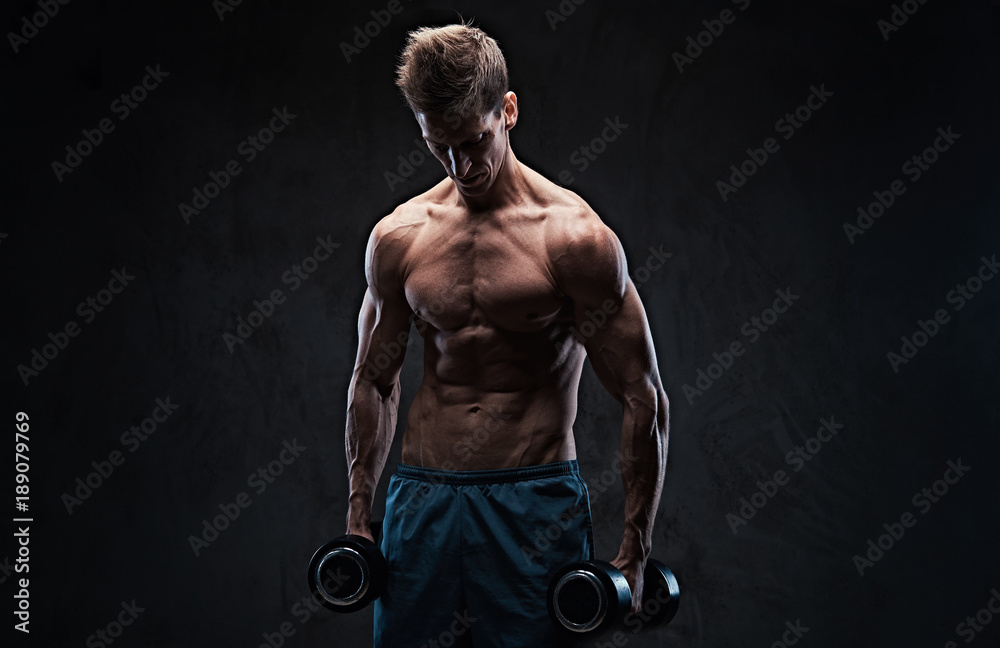 Athletic shirtless male biceps dumbbell workout. Athletic shirtless male biceps dumbbell workout.