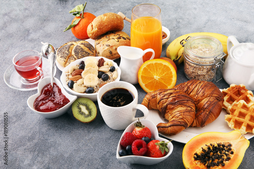 Breakfast served with coffee, orange juice, croissants and fruits. Balanced diet.