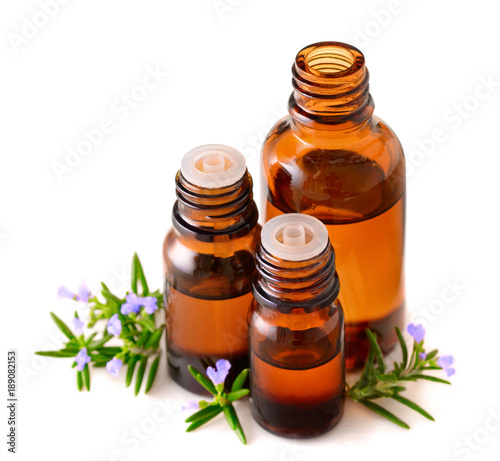 fresh rosemary flowers and essential oil isolated on white