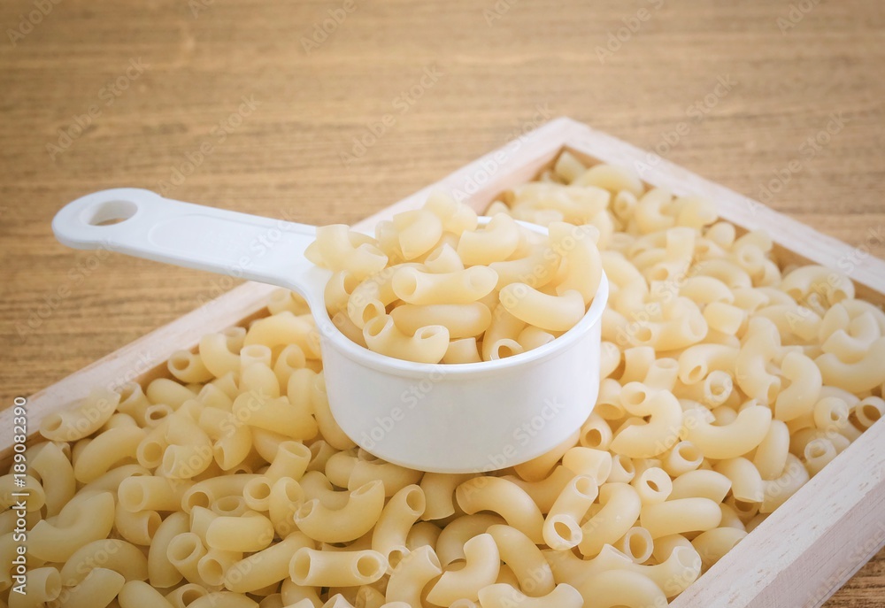 Elbow Macaroni or Gomiti Pasta in Measuring Cup Elbow Macaroni or Gomiti Pasta in Measuring Cup