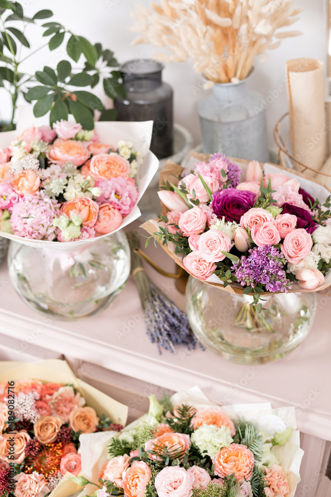 Few of beautiful luxury bouquet. Mixed flowers on pink table. the work of the florist at a flower shop. Wedding Few of beautiful luxury bouquet. Mixed flowers on pink table. the work of the florist at a flower shop. Wedding