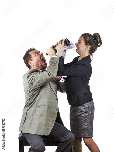 The boss is drunk and the secretary is trying to take away his bottle of alcohol