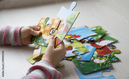 Wallpaper Mural hands collect puzzle on the table, the concept of lifestyle Torontodigital.ca