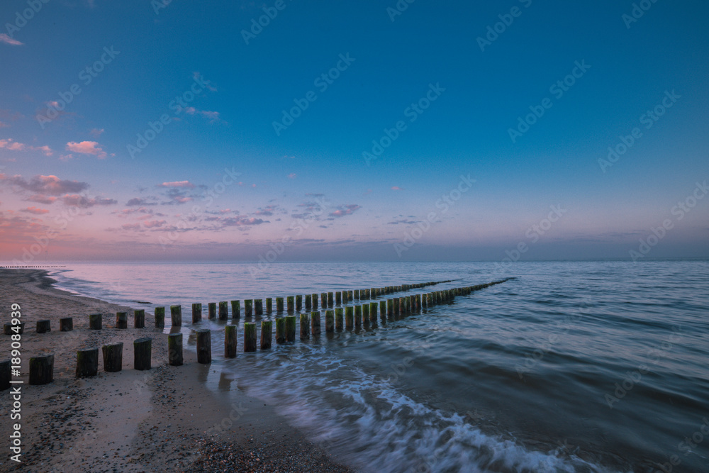Timber Piles In The Morning At Renesse Zeeland / Netherland