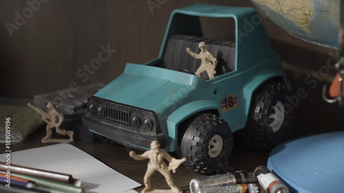 Toy Soldiers and Tanks. Miniature toy soldiers on board photo