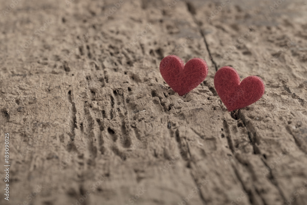 Fototapeta premium small red hearts on wooden background