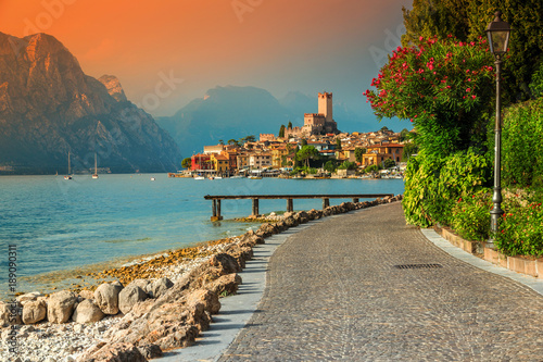 Fantastic Malcesine tourist resort and colorful sunset, Garda lake, Italy