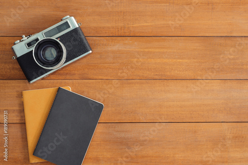 Minimal work space - Creative flat lay photo of workspace desk. Office desk wooden table background with mock up notebooks and retro camera. Top view with copy space, flat lay photography photo