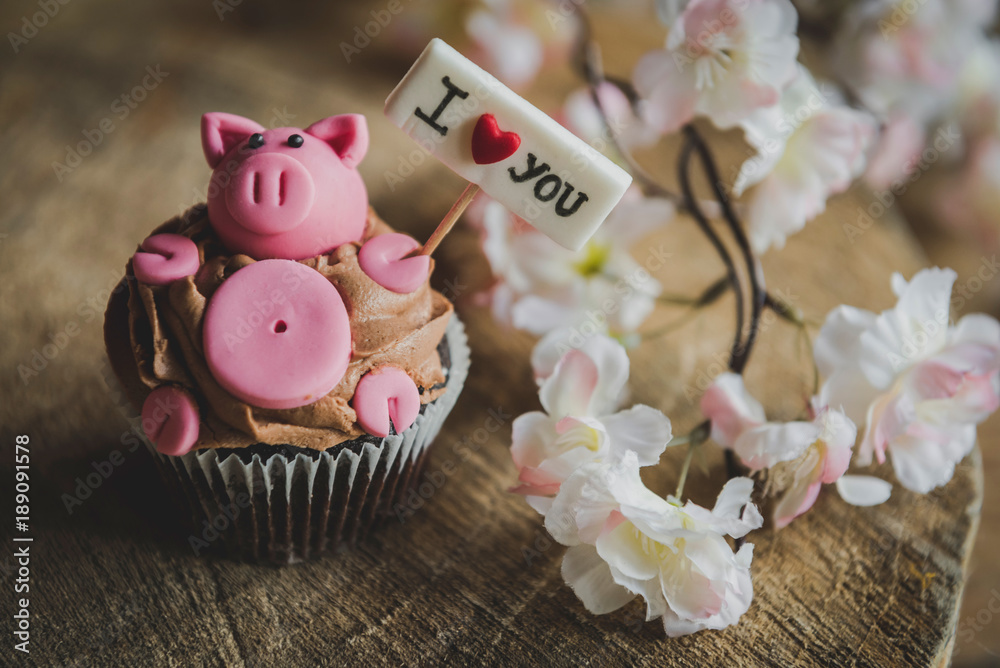 Sweet pig with I love you sign on the top of cup cake,selective focus Sweet pig with I love you sign on the top of cup cake,selective focus