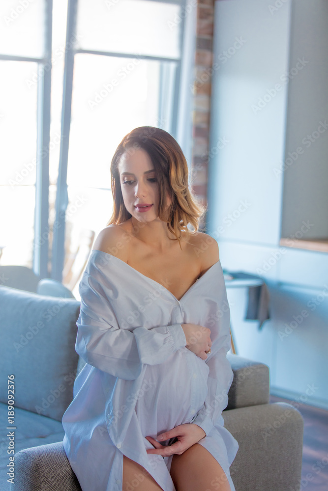 Young redhead pregnant woman in white clothes Young redhead pregnant woman in white clothes