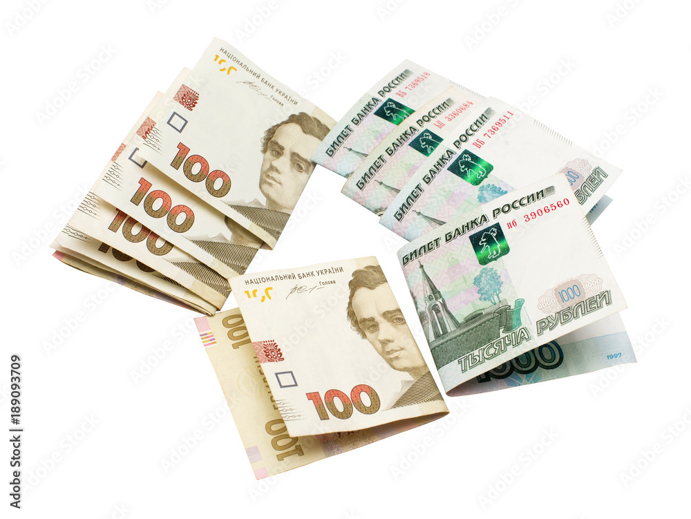 One hundred Ukrainian national currency hryvnia and one thousand rubles of Russian isolated on white background. Finance, international politics One hundred Ukrainian national currency hryvnia and one thousand rubles of Russian isolated on white background. Finance, international politics